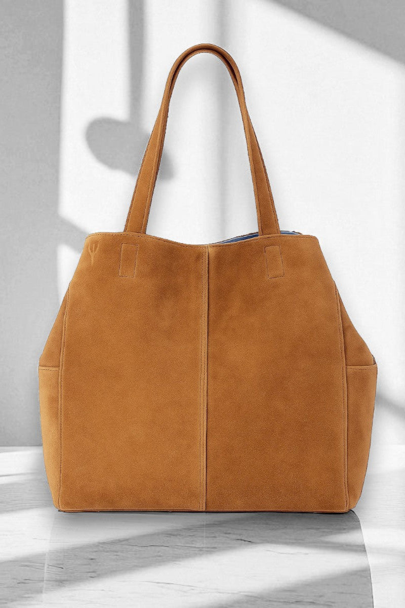 Tan suede tote bag on a light gray background